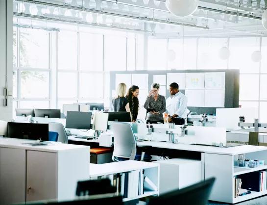 Business meeting to discuss ESG concerns in an open-concept office
