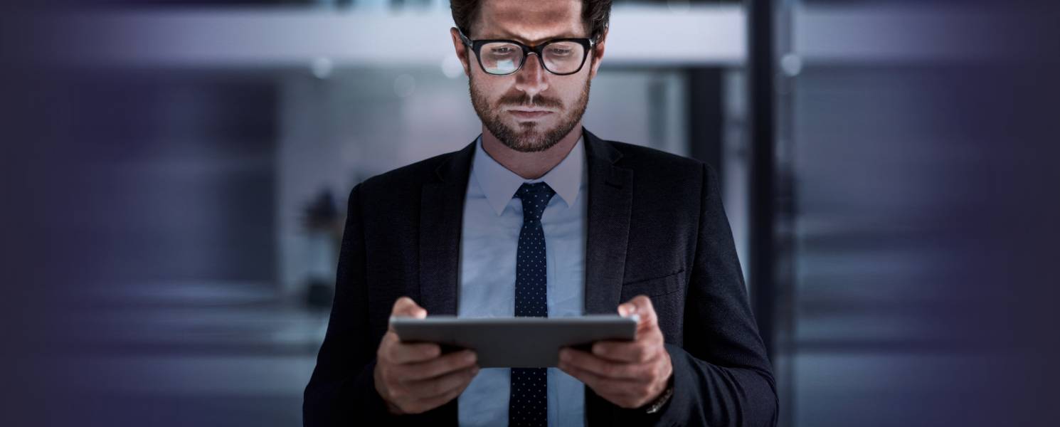 Businessman looking down at a tablet
