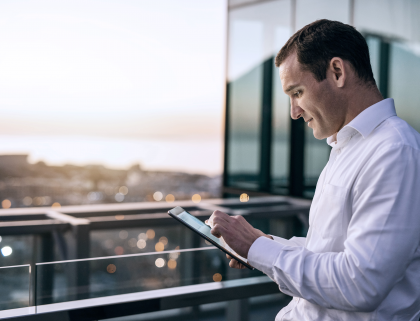 Businessman using a tablet on a balcony