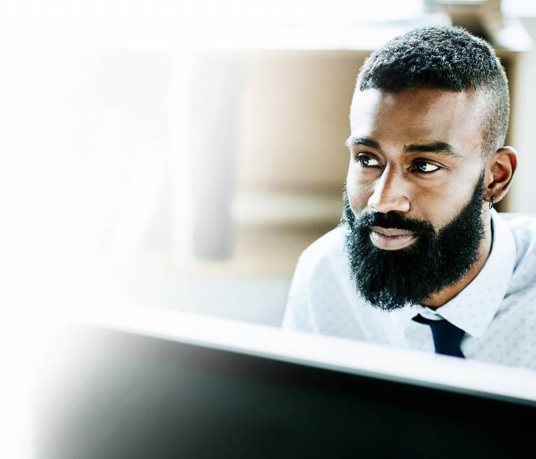 Businessman on his computer looking accomplished