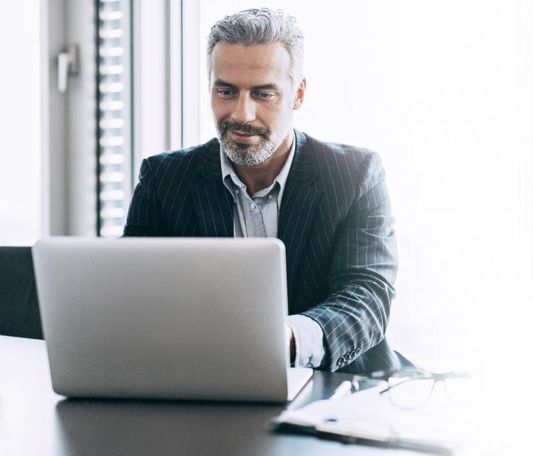 Businessman viewing proxy solutions on his laptop