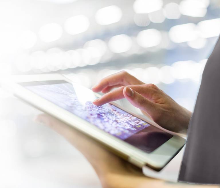 Businessperson using a tablet device to stay organized