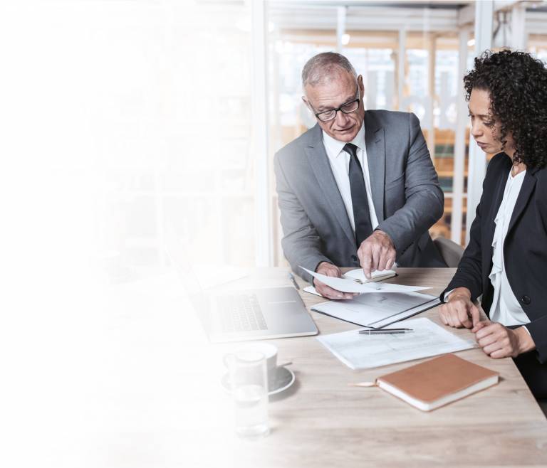 Businessman and businesswoman giving design input looking at a proxy draft