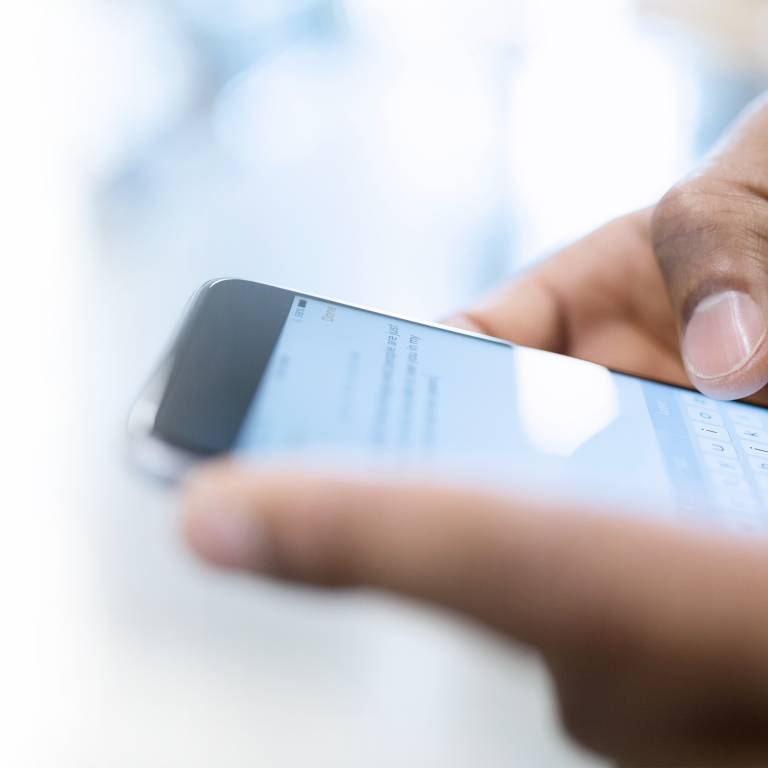 Closeup of a man holding a phone in his hands