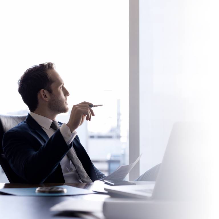 Man thinking about improving internal controls and reducing the risk of errors while managing shareholder reports with ArcReporting.
